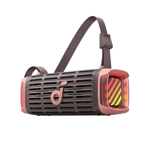 Close-up of a pink and gray handheld device with a vented body and a woven strap looping over its top, featuring a small 'soundcore' label on the strap.