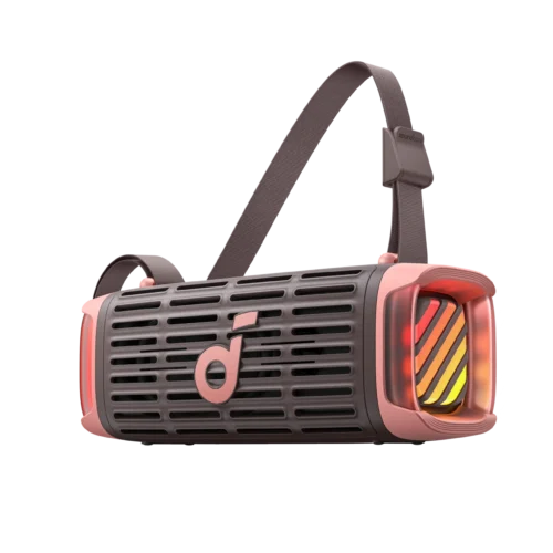 Close-up of a pink and gray handheld device with a vented body and a woven strap looping over its top, featuring a small 'soundcore' label on the strap.