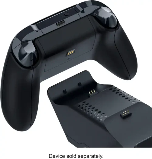 55b0dc7b-75ab-49cb-aebd-15ad4c2d915e Black wireless game controller with a separate charging dock; battery contacts visible on the controller and dock.