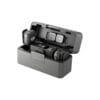 DJI Mic 3 wireless microphone system shown in an open charging case with two transmitters and a receiver inside