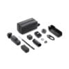 Assorted DJI Osmo accessories spread on a white background, including a gray carrying case, mounts, cables, and adapters.