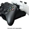 919e1ff4-727b-4a45-a552-87034d9e5626 Black game controller atop a white controller with colored A, B, X, Y buttons; caption reads 'Devices sold separately'