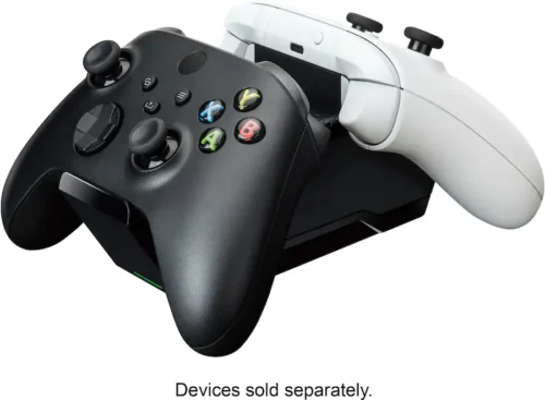 919e1ff4-727b-4a45-a552-87034d9e5626 Black game controller atop a white controller with colored A, B, X, Y buttons; caption reads 'Devices sold separately'