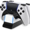 fbaf9c63-efe1-462a-a982-3614761bb044 (1) White PlayStation DualSense controller resting on a black charging dock with blue LED accents on the edges.