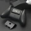 next-accessories-xbox-NXXCHRG2-54190026-1-1024x683 Black wireless game controller with a removable battery pack and charging dock on a dark surface, controller shown from the top/side view with battery slot open.