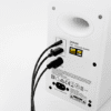 Rear view of a white Edifier M60 multimedia speaker with two black cables plugged into the input/output ports on the back panel